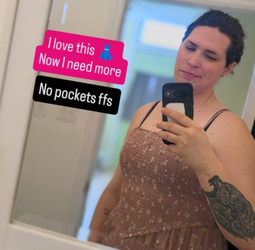 Harper taking a mirror selfie in a pink dress