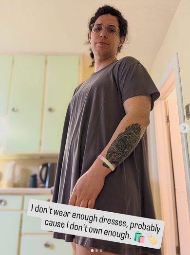 Harper standing in a grey dress